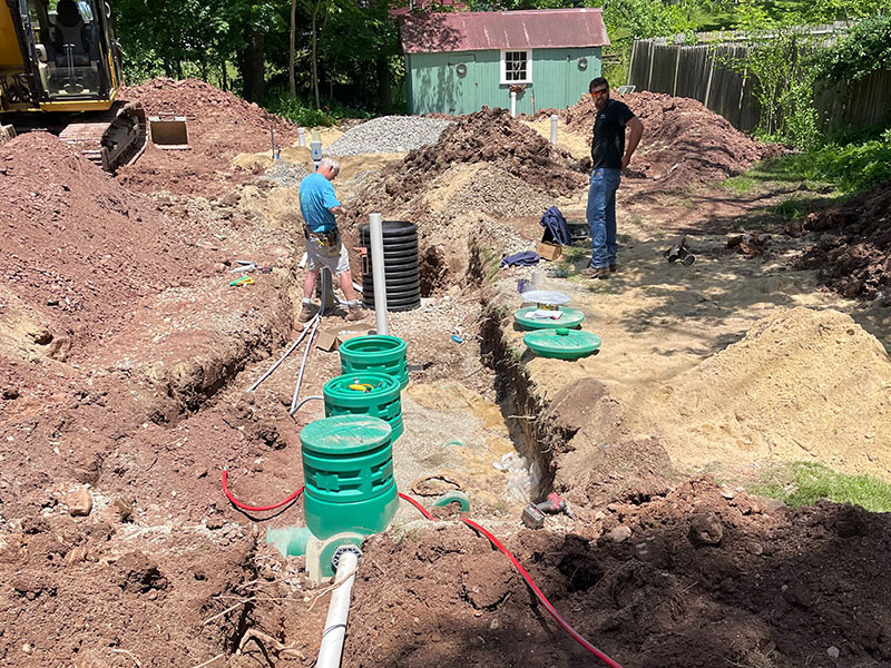 Two men installing a septic system